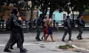Members of the military police special unit detain suspected drug dealers during a police operation against drug trafficking at the favela do Penha, in Rio de Janeiro, Brazil October 28, 2025. REUTERS/Aline Massuca